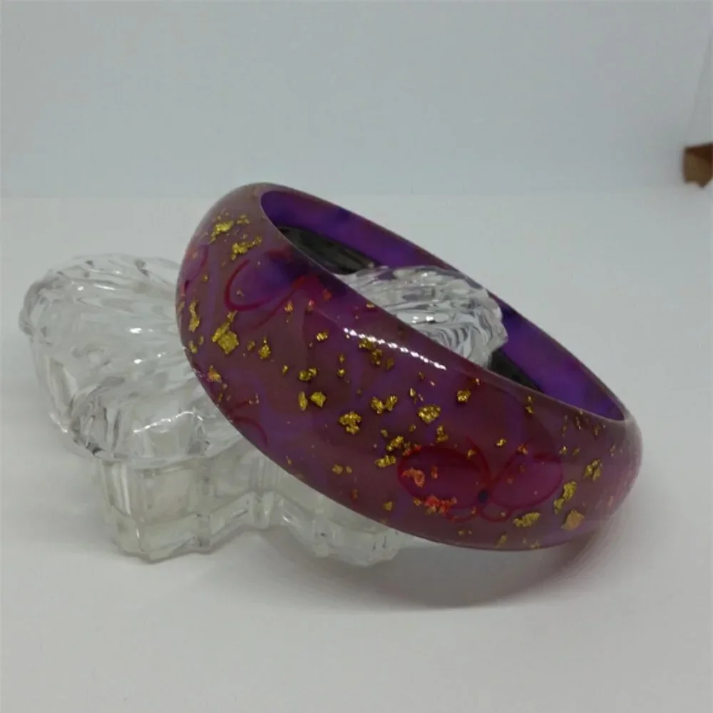 Lucite style purple bangle bracelet with glitter flakes and butterflies